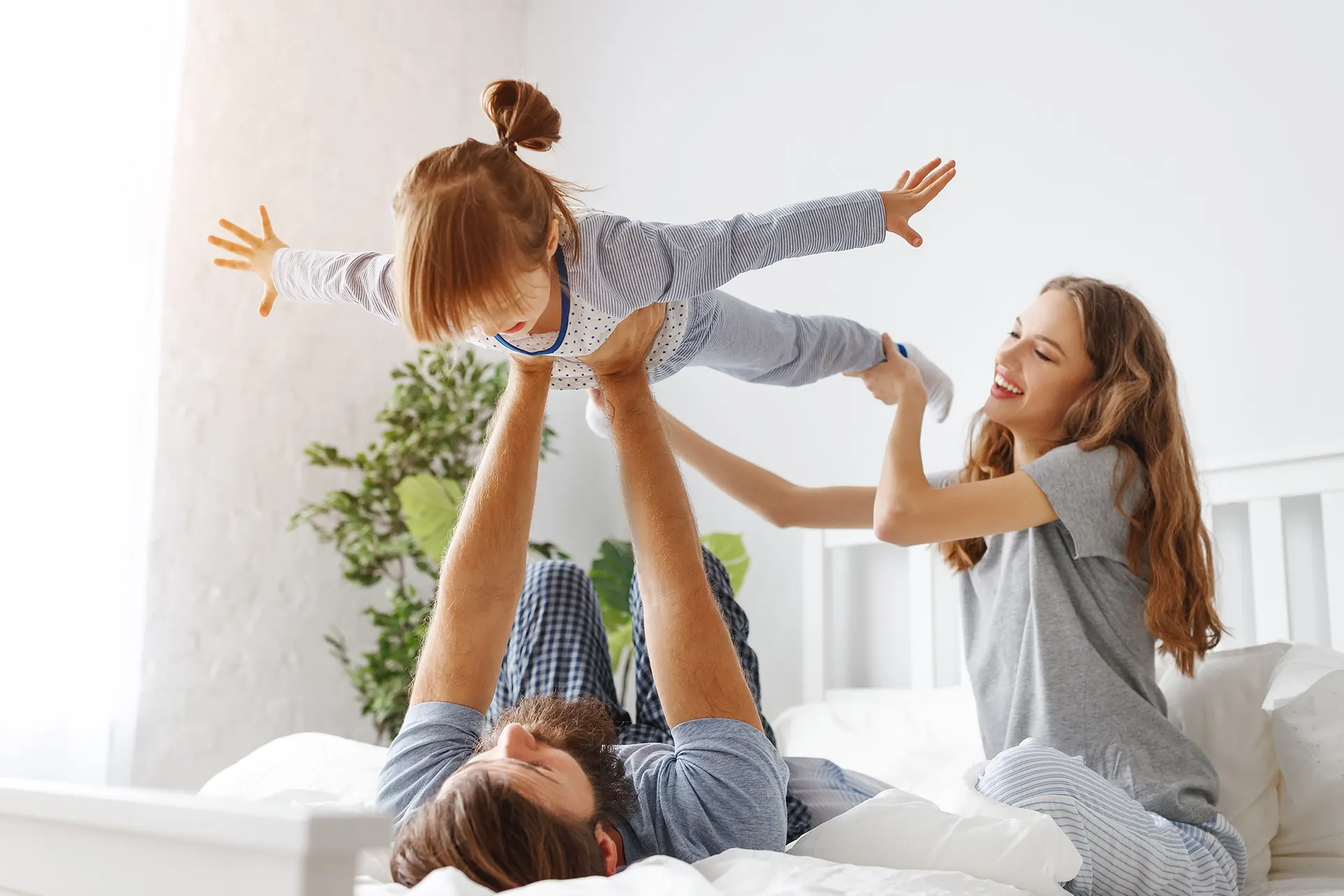 Family playing together on a new mattress